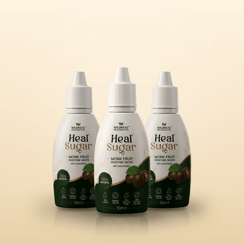 Three white plastic dropper bottles of monk fruit sweetener stand side-by-side on a light beige background, each featuring dark green labels with the product name Heal Sugar in bold lettering.